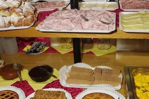 Bufet z pieczywem, wędlinami, serami, waflami i jajecznicą.