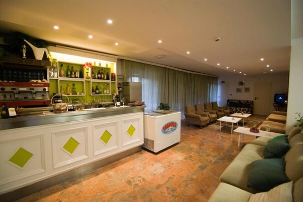 Nowoczesny hotelowy salon z barem, kanapami i fotelami.